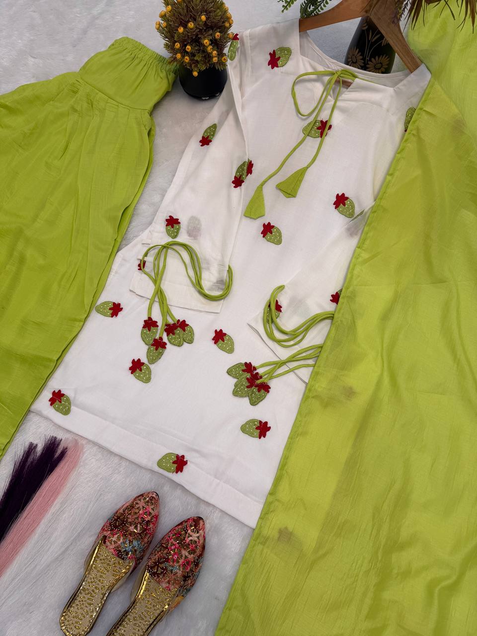Ethereal Ivory White Short Kurti Adorned with Delicate Floral Embroidery and Tassel Detailing, Paired with a Vibrant Mehendi Green Salwar